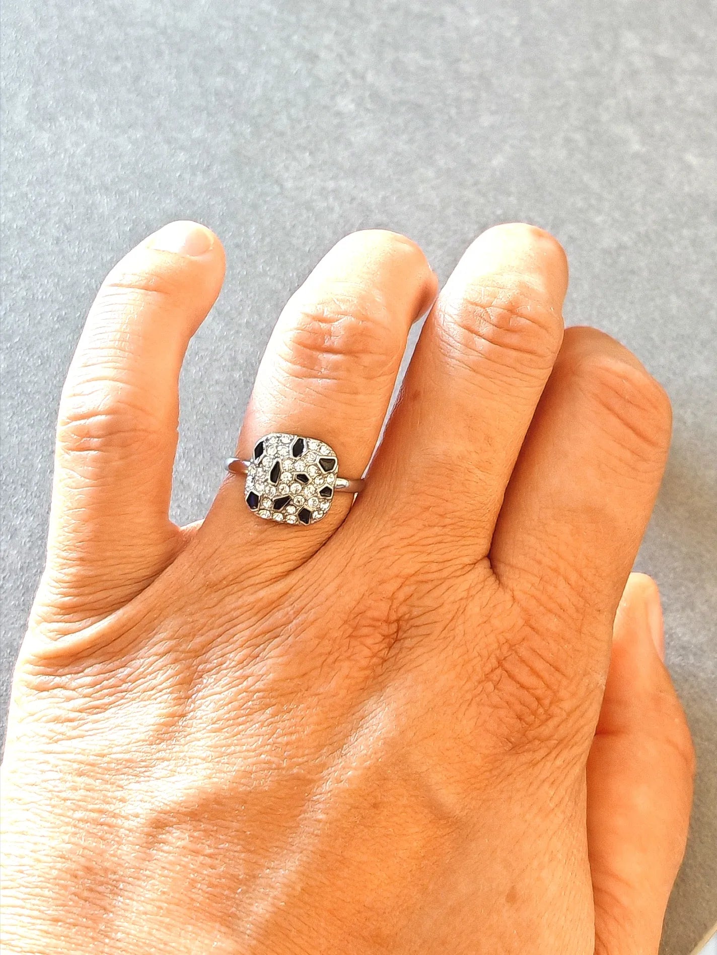 Brillez de mille feux avec cette bague argentée ornée de cristaux scintillants et de détails noirs contrastants. Son design moderne et raffiné apporte une touche d’élégance à toutes vos tenues, de jour comme de soirée.