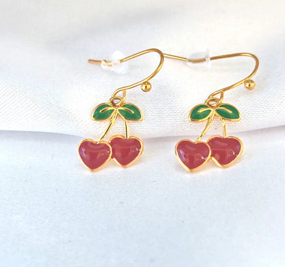 🍒 Un brin rétro, une touche pop, un bijou qui pétille
Des boucles d’oreilles qui ne passent pas inaperçues – fraîches, fruitées, féminines.

Ces boucles d’oreilles cerise pendantes sont la définition même du bijou ludique et stylé. Inspirées des années 60 avec une touche contemporaine, elles arborent deux jolies cerises rouges émaillées suspendues à de fines tiges dorées en acier inoxydable. Ultra légères et confortables, elles oscillent délicatement à chaque mouvement, ajoutant une note gourmande, audacie