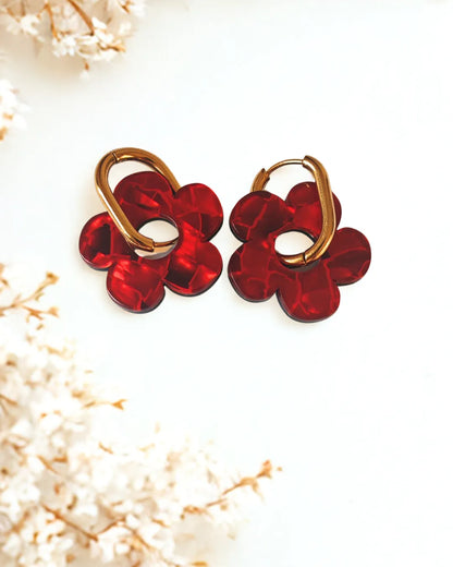 Faites rayonner votre style avec ces boucles d’oreilles dorées ornées de fleurs rouges en résine effet nacré. Leur design à la fois rétro et moderne apporte une touche de couleur vibrante et élégante à toutes vos tenues.