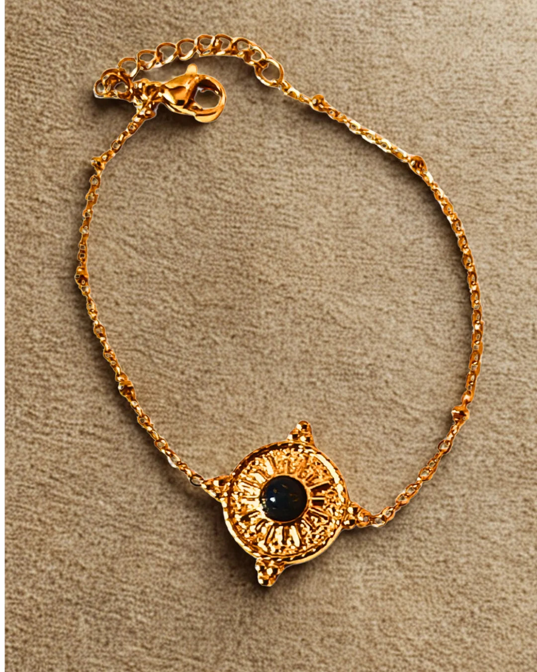 Bracelet raffiné en acier inoxydable doré orné d’un soleil et d’une pierre noire. Élégant, symbolique et résistant à l’eau, idéal à offrir ou à porter au quotidien.