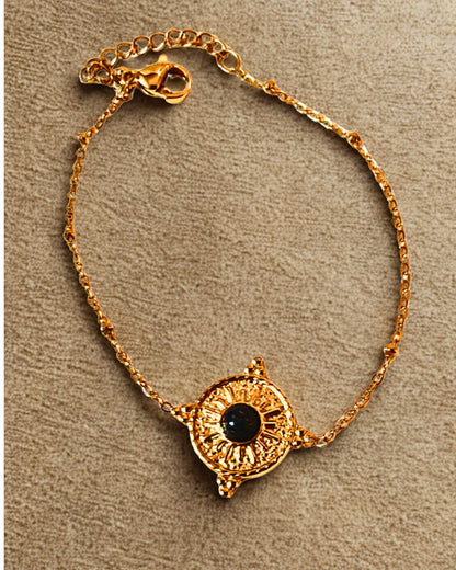 Bracelet raffiné en acier inoxydable doré orné d’un soleil et d’une pierre noire. Élégant, symbolique et résistant à l’eau, idéal à offrir ou à porter au quotidien.